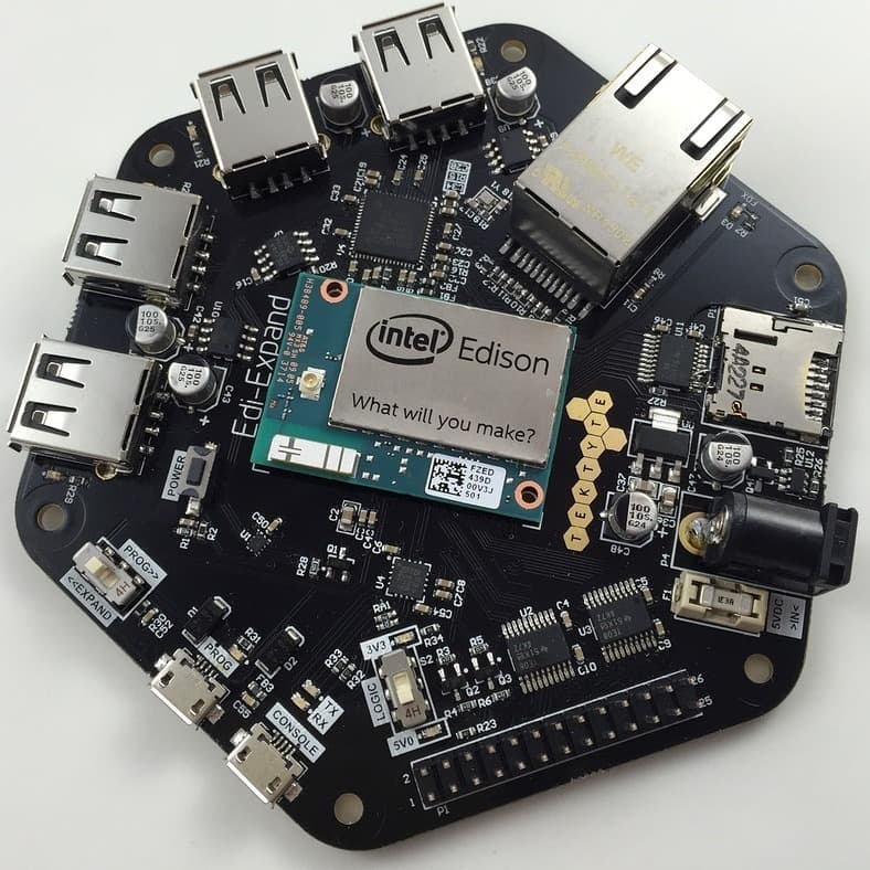 An Intel Edison module seated on a TEKTYTE Edi-Expand carrier board with five USB ports, ethernet, a micro SD slot and a barrel jack