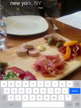 A search screen for New York with a full-bleed dish photograph above the keyboard