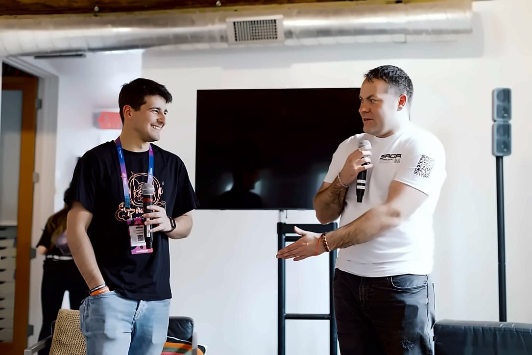Two speakers with microphones talking to the room during a session inside the house